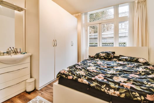 a bedroom with a bed, dresser and mirror on the wall in front of the door to the bathroom area