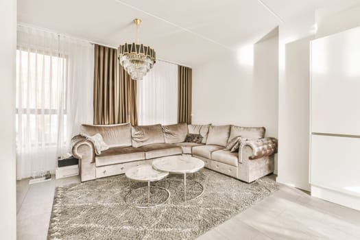 a living room with couch, coffee table and chandels on the wall in the room is very white