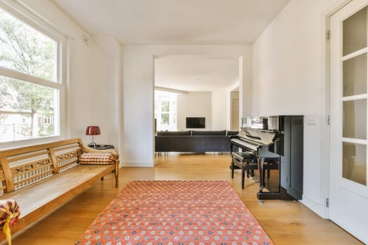 a living room with a piano in the middle and an area rug on the floor that looks like a carpet