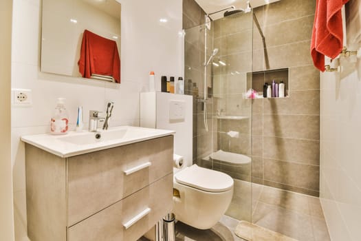 a bathroom with a toilet, sink and shower stall in the same color as it appears on the wall or floor