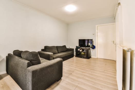 a living room with two couches and a flat screen tv on the wall in the room is very clean
