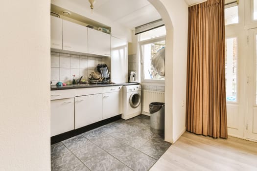 a laundry room with a washer, dryer and washing machine on the floor in front of the door