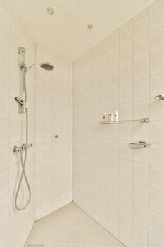 a white tiled bathroom with shower head and hand rails in the wall is made out of ceramic tiles on the floor