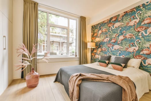 a bedroom with flamings on the wallpaper and wooden floors in front of the bed, there is a pink plant next to