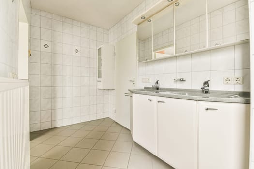 a bathroom with white cabinets and marble counter tops on the floor, in front of a large mirror over the sink