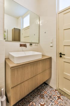 a bathroom with a sink, mirror and toilet paper on the floor in front of the door to the room