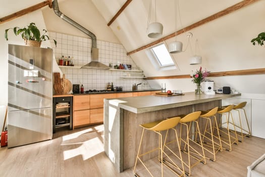 a kitchen with wooden flooring and white tiles on the walls, two yellow stools are in front of the counter