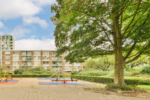 an apartment complex with playgrounds and play areas in the foreground area, near to london's hyde park