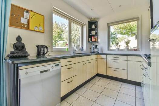 a kitchen area with white cabinets and black counter tops on the counters in this photo is taken from the inside