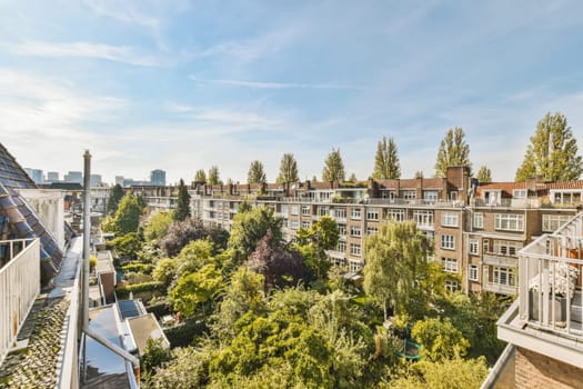 an apartment with trees and buildings in the background, taken from our balcony window looking out to the city below