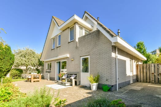 the outside of a house that has been painted white and is being used as an outdoor area for picnics
