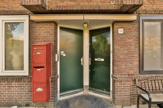 a brick building with a green door and red mailbox in the doorway is visible on the left side of the photo