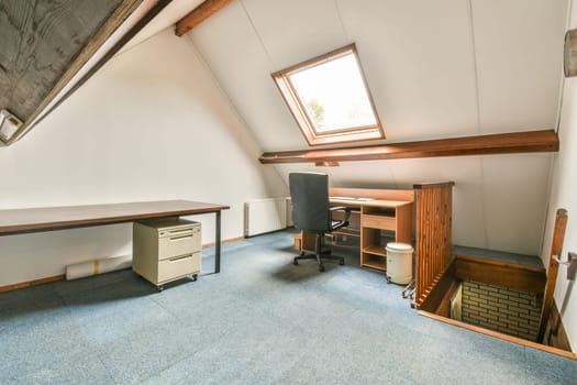 a home office area with blue carpet and wooden desks in the room is very spacious, but it's not too
