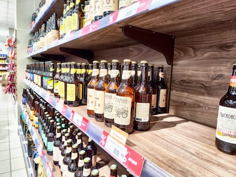 Kirov, Russia - March 14, 2025: Various bottles of craft beer are neatly arranged on shelves in a store, highlighting a diverse selection for customers.