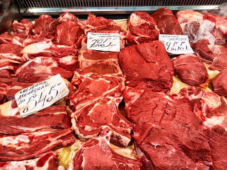 Kirov, Russia - March 27, 2025: A variety of fresh cuts of red meat laid out in a butcher shop, showcasing different selections available for customers to purchase.
