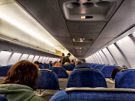 Irkutsk, Russia - April 04, 2025: Passengers are seated in an airplane cabin, preparing for departure to Irkutsk, Russia on a scenic travel journey.