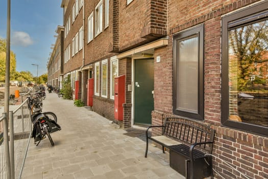 a bike parked on the side of a street in front of a brick building that has been painted red and white