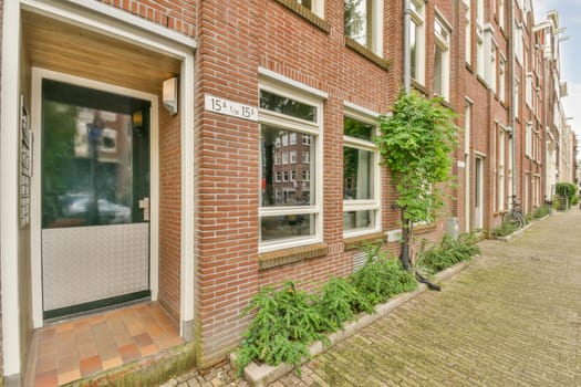 a brick building with plants growing in the doorways and on the side of the building there is a street sign that says no