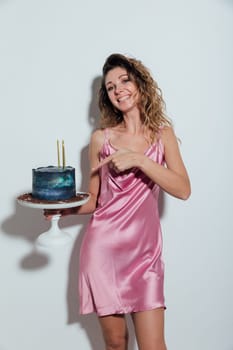 Beautiful slender woman pastry chef with birthday cake smiling