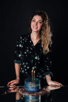 Beautiful slender woman pastry chef with birthday cake smiling