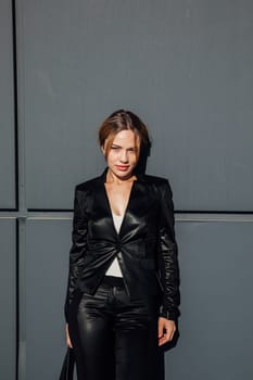 Portrait of a beautiful woman with a short hairstyle in a black fashion suit