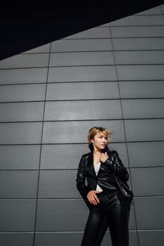 Portrait of a beautiful woman with a short hairstyle in a black fashion suit