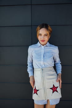 Portrait of a beautiful slender woman fashionably walking on the street