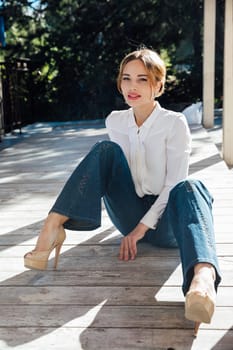 Portrait of a beautiful slender blonde woman fashionably walking on the street