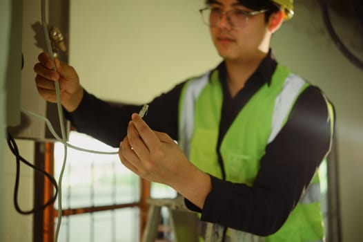 Close up of worker connecting LAN cable during a renovation project.