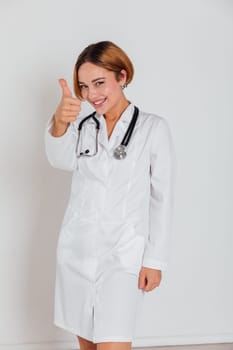 Beautiful Woman Doctor With Stethoscope In Hospital Showing Hand Thumbs Up