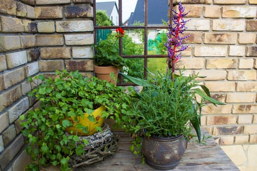 beautiful place in the garden in the mediterranean style, pots with plants on the table