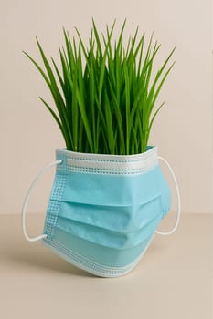 Mask on grass in pot, AI generation.