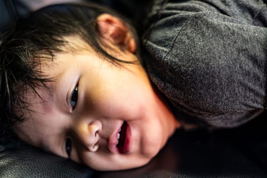 Toddler Sitting In A Black Leather Office Chair, Background for advertising and wallpaper in kids and lifestyle scene.