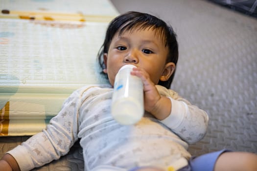 Toddler Drinking Milk In The Playroom, Background for advertising and wallpaper in kids and lifestyle scene.