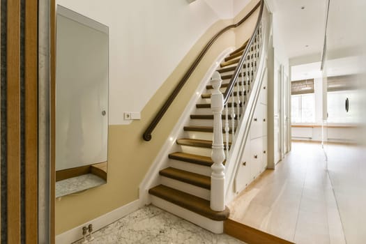 A beautifully designed staircase with a white balustrade and soft lighting, enhancing the elegance of the interior space. Ideal for modern home decor inspiration.