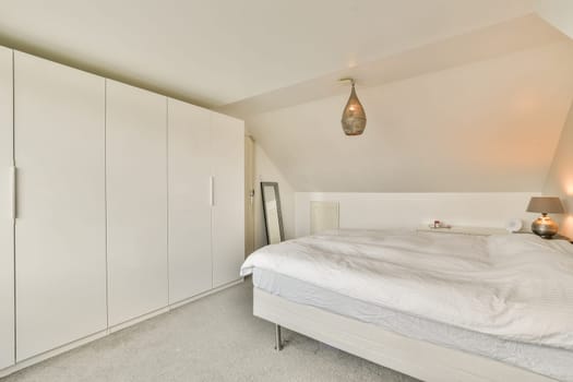 A contemporary bedroom featuring sleek furniture, soft bedding, and stylish lighting that creates a tranquil atmosphere for relaxation and rest.