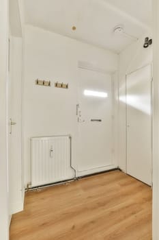 Bright and spacious entryway featuring clean lines, light-colored walls, and wooden flooring, creating a welcoming atmosphere.