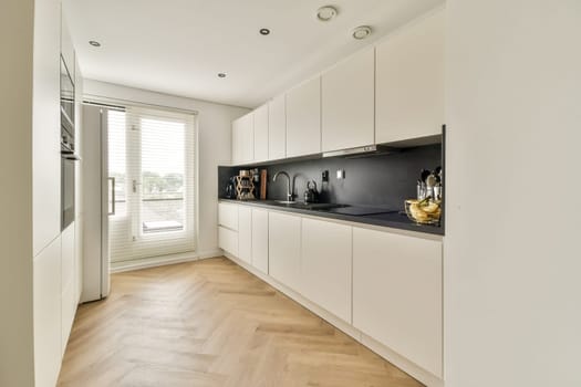 A sleek, modern kitchen featuring white cabinetry, minimalist design, and a stylish layout that invites elegance and functionality.