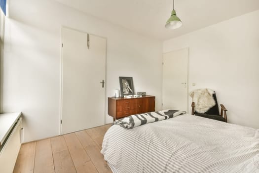 A serene and minimalist bedroom featuring a simple bed, elegant decor, and natural light filtering through the windows, creating a tranquil space.