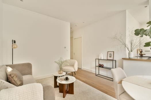 A stylish modern living room featuring neutral colors, elegant furniture, and decorative elements that create a warm and inviting atmosphere.