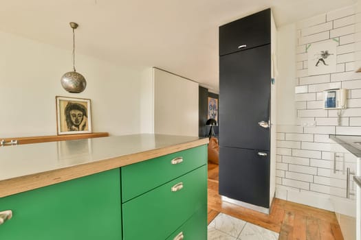 Stylish modern kitchen featuring vibrant green cabinets, a minimalist design, and contemporary decor elements, creating an inviting and functional space.
