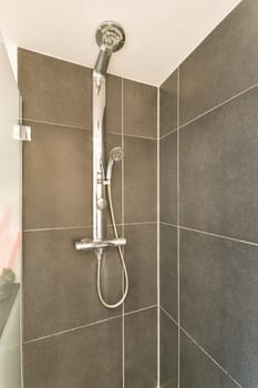 Sleek shower fixture mounted on a tiled wall, showcasing a contemporary design ideal for modern bathrooms.