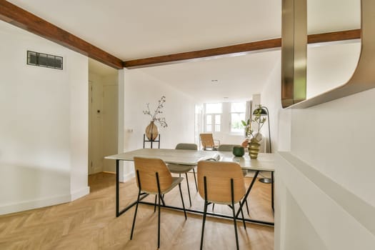 A spacious, well-lit room featuring a minimalist design with wooden accents and a simple furniture layout. Natural light enhances its tranquil ambiance.