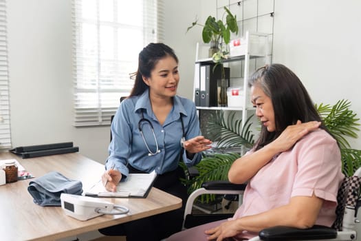 A nurse attentively engages with her elderly patient, addressing health issues and ensuring comfort during the consultation.