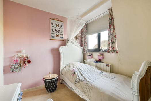 A beautifully decorated bedroom showcasing soft pastel colors, floral curtains, and butterfly art, creating a warm and inviting atmosphere.