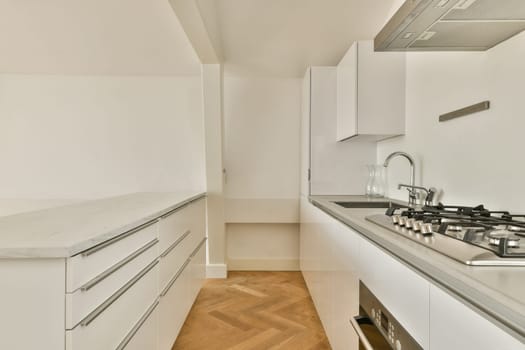 A sleek modern kitchen featuring white cabinetry, gray countertops, and elegant fixtures for a contemporary cooking space. Ideal for design enthusiasts.