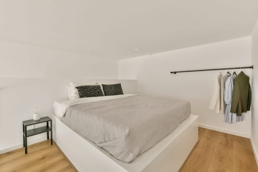 A sleek and modern bedroom featuring a cozy bed with light bedding, minimalist decor, and a clean design that promotes relaxation and tranquility.