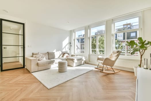 Spacious living room featuring minimalist decor, large windows, and a comfortable seating arrangement, providing a bright and cozy atmosphere.