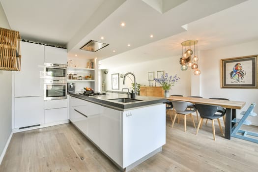 A contemporary kitchen featuring stylish cabinetry, elegant fixtures, and an inviting dining area, perfect for family meals and gatherings.
