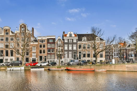 Picturesque view of Amsterdam's canals showcasing beautiful historic buildings and the vibrant city life along the waterfront.